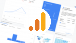 Blurred Google Analytics dashboard report with Google Analytics logo.