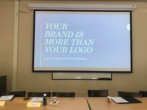 Slideshow and conference table at Clark University from our brand marketing workshop.