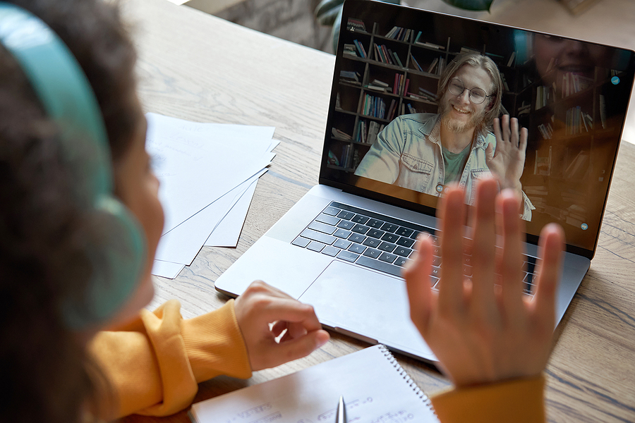 A salesperson building virtual rapport with a prospective client via a video-conferencing app.