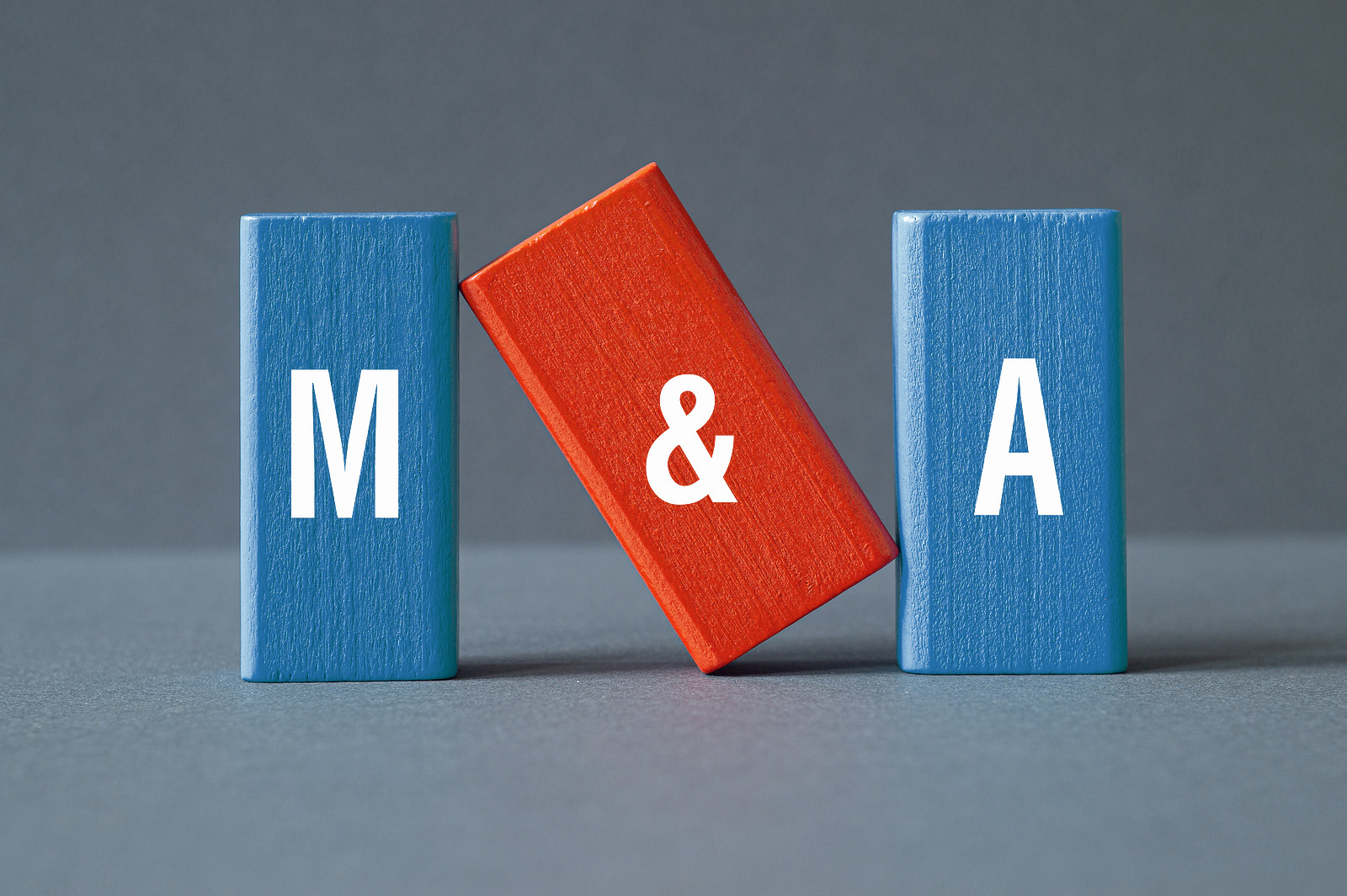 Building blogs with M & A on them, representing mergers & acquisitions.